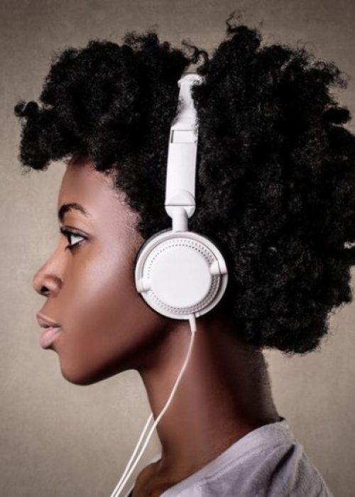 portrait-young-black-female-with-curly-hair-listening-music-with-white-headphone_181624-41291-600x555